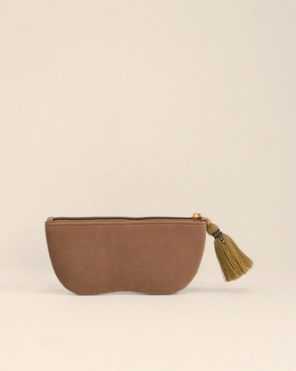 Brown pouch with a tassel on a beige background