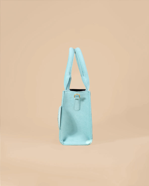 Light blue handbag on a beige background