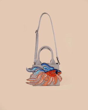 Handbag with fish design on a beige background