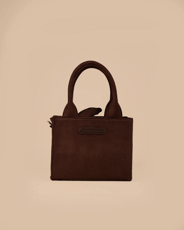 Brown handbag on a beige background