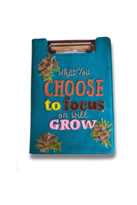 Blue towel with motivational quote and floral designs on a blue background